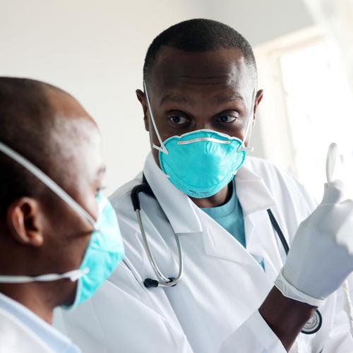 A doctor and hospital staff go over TB care together in a hospital.