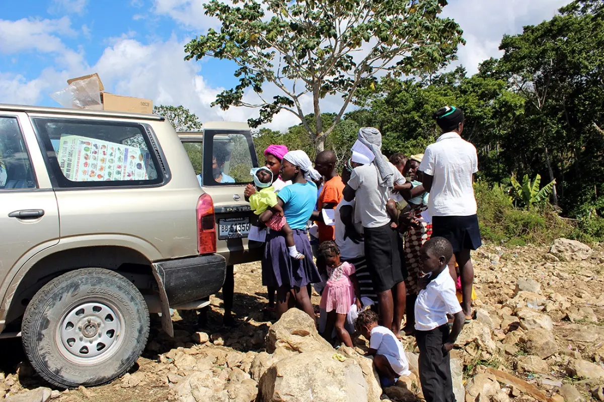 Residents line up for food assistance from a mobile clinic in Haiti.